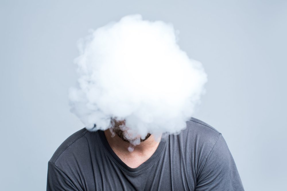 Face covered with thick white smoke isolated on light background